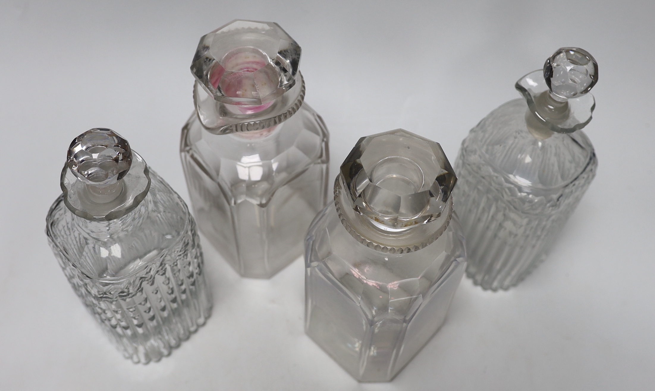 Two pairs of Georgian moulded and cut glass square decanters, all with lips, stoppers and ground pontils, highest 20cm (4)
